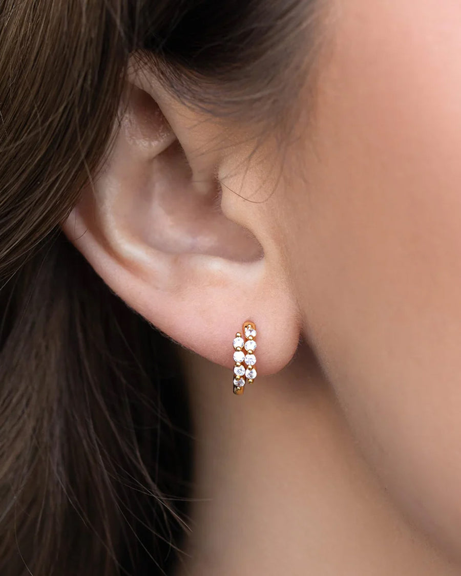 model wearing gold hoops with two crystal rows