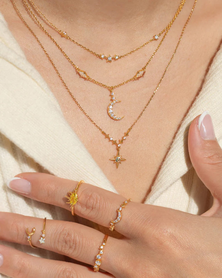model wearing gold double layered crystal moon and star necklace