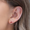 model wearing red mushroom stud earrings
