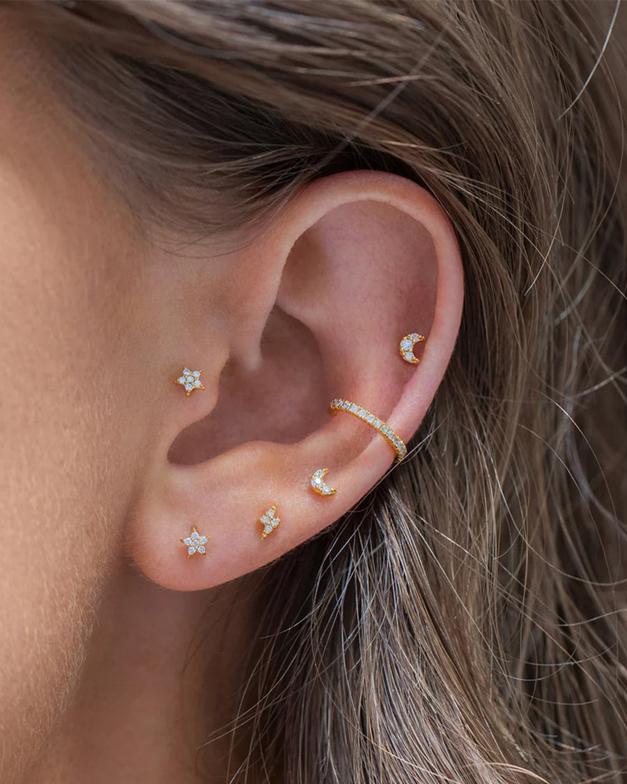 model wearing set of three crystal galaxy earrings: lighting bolts, stars, and moons