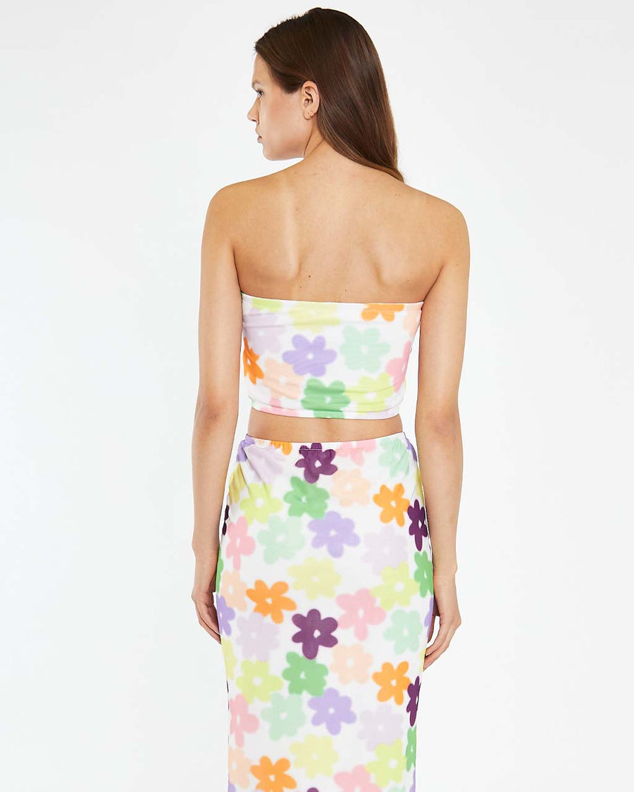 back view of model wearing white mesh cropped tube top with colorful abstract flowers
