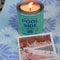 teal pool side candle on a beach towel