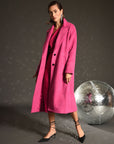 model wearing long hot pink wool coat