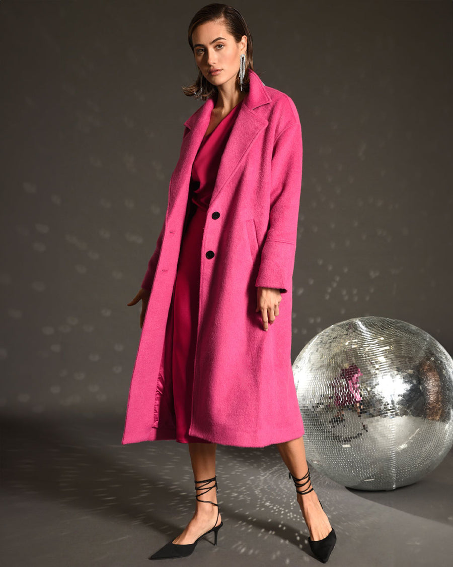 model wearing long hot pink wool coat