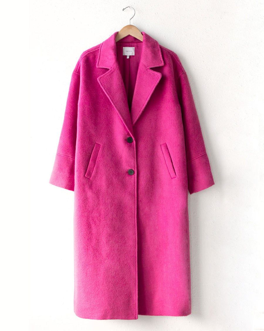 long hot pink wool coat with two button front, lapel and slit pockets