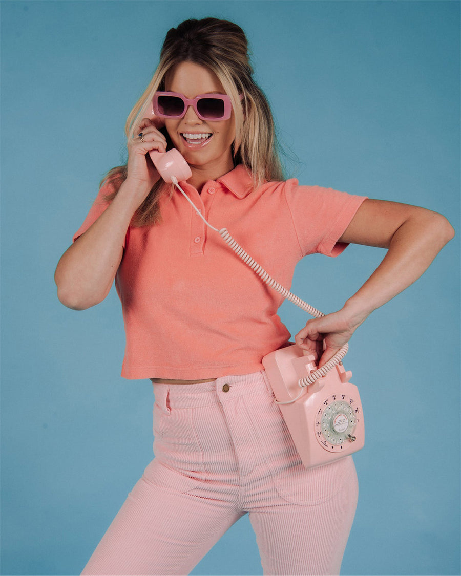 model wearing watermelon cropped terry cloth polo top