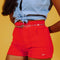 model wearing bright red corduroy shorts