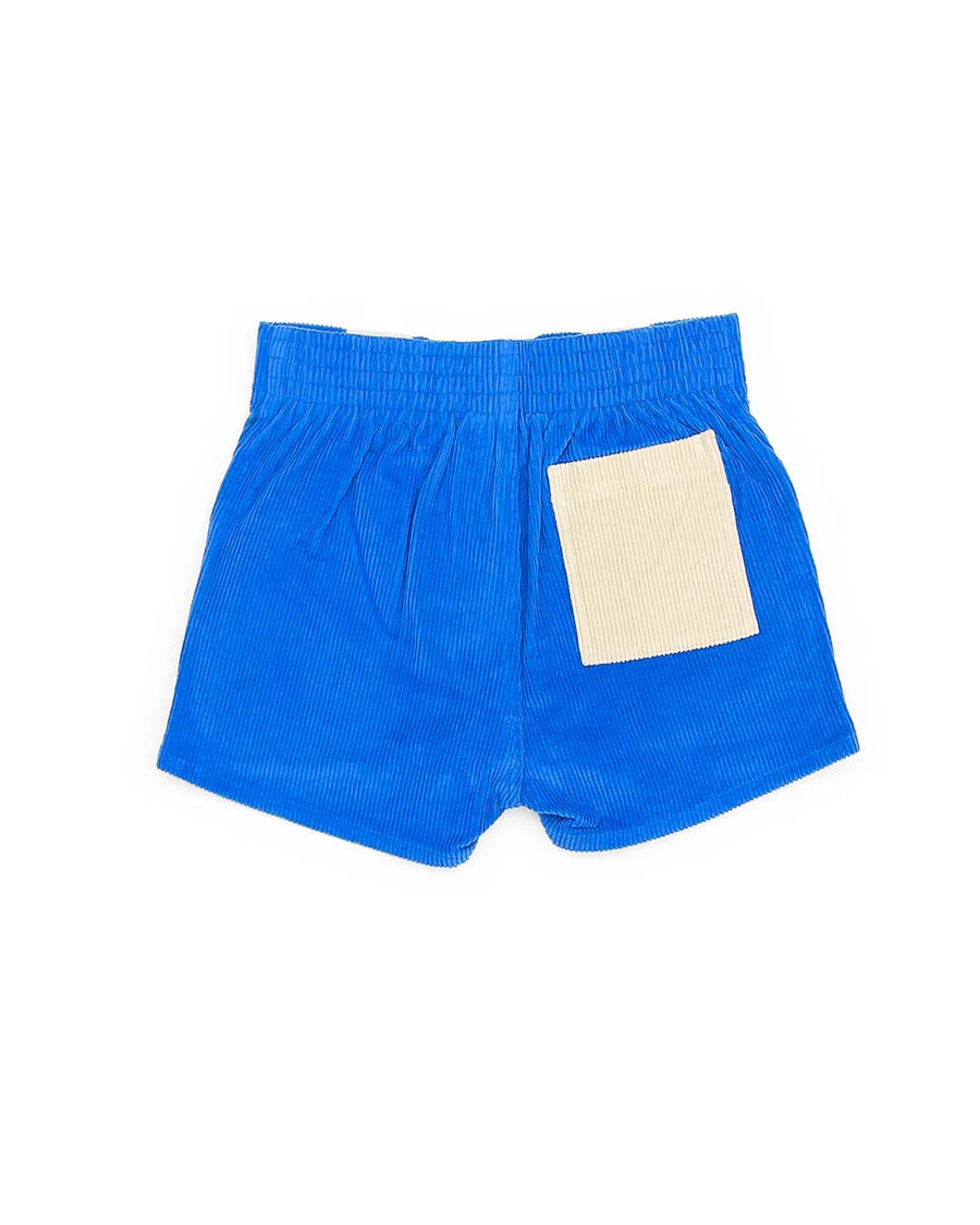 back view of two-tone corduroy shorts in sand and bright blue