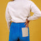 back view of model wearing two-tone corduroy shorts in sand and bright blue