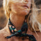 model wearing black bandana with gold, pink, & green flowers