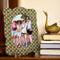 green and peach aztec print scalloped fabric picture frame with picture inside