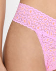 side view of model wearing pink and orange leopard lace thong
