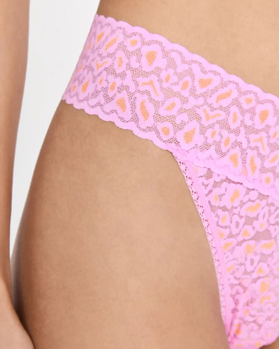 side view of model wearing pink and orange leopard lace thong