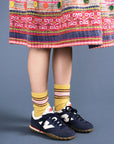 model wearing yellow crew socks with pink stripe