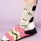 up close of model wearing beige crew socks with guinea pig and leaf print