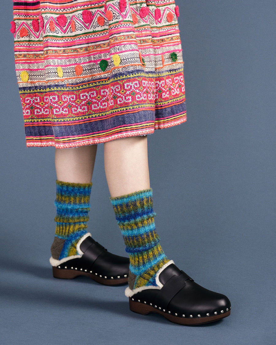 model wearing chunky boot socks with red, green and brown stripes