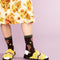 model wearing black socks with brown dog and daffodil print