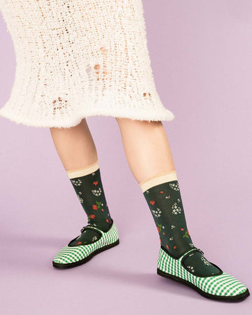 model wearing green socks with delicate floral print and cream trim