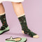 up close of model wearing green socks with delicate floral print and cream trim