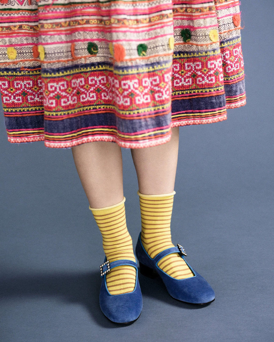 model wearing yellow crew socks with brown thin stripes