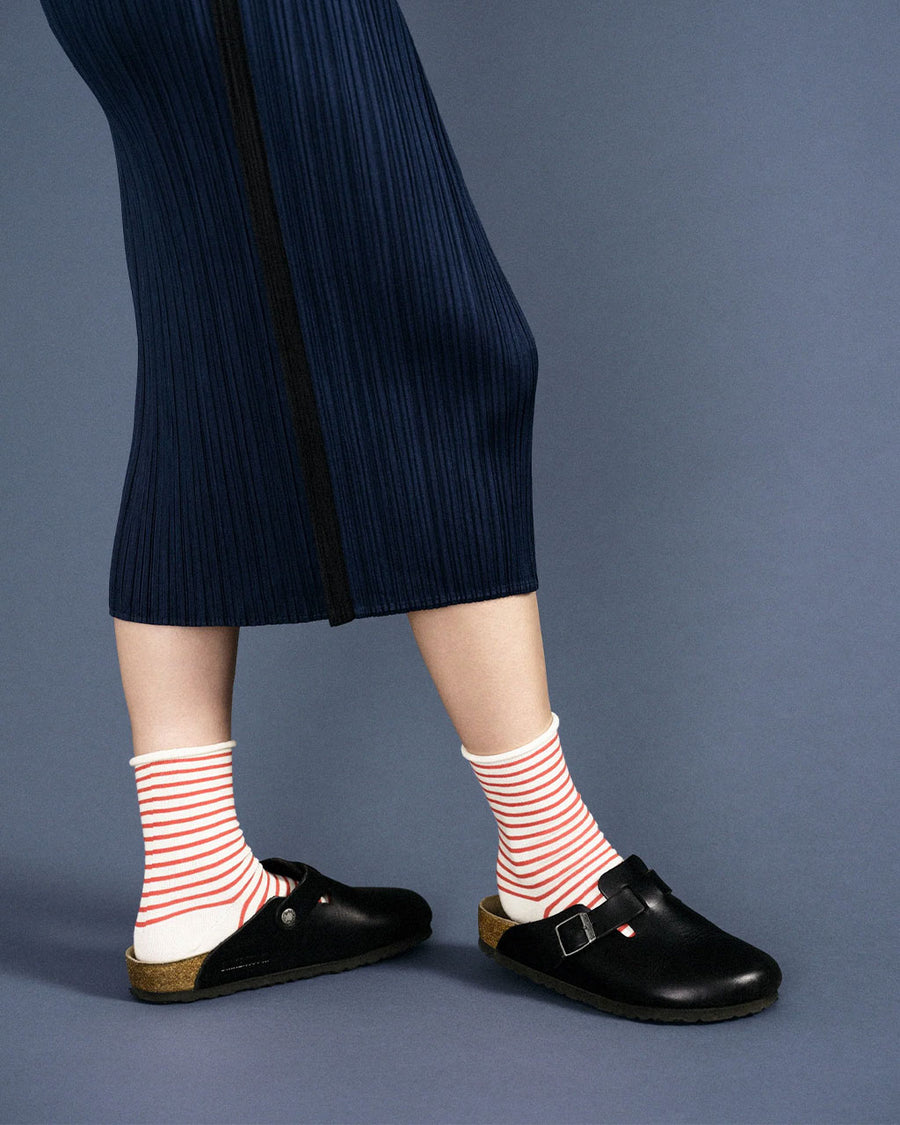 model wearing white roll down socks with thin pink stripes