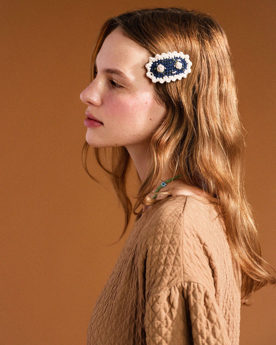 model wearing navy crochet hair clip