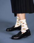 model wearing white socks with pringle like potato chip graphic