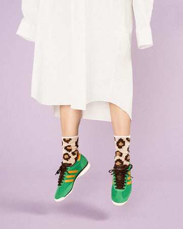 model wearing tan pixelated leopard print crew socks
