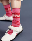 up close of model wearing pink crew socks with red and white static design