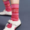up close of model wearing pink crew socks with red and white static design