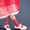 model wearing pink crew socks with red and white static design