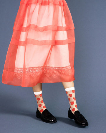 model wearing sheer crew socks with red heart print
