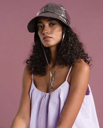 model wearing black and white gingham tulip bucket hat