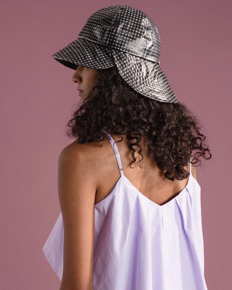 sideview of model wearing black and white gingham tulip bucket hat