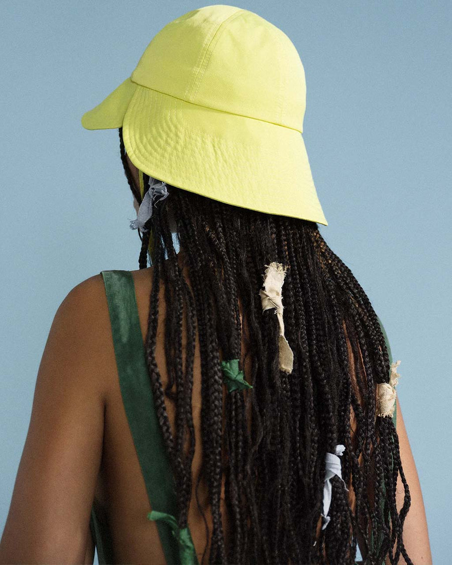 back view of model wearing lemon tulip bucket hat with straps