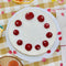 top view of set of 10 strawberry shapes birthday candles on cake