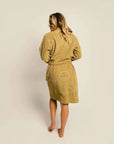 backview of model wearing burnt mustard robe with embossed smiley design