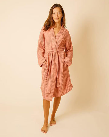 model wearing terra cotta waffle bathrobe
