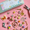 assorted jewelry pieces laid out on a pink background