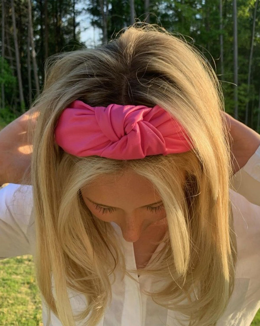 top view of hot pink pleather knotted headband