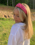 model wearing hot pink pleather knotted headband