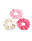 set of three scrunchies: pink and white checkered, white, and pink pleather