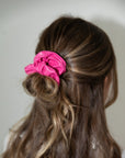 model wearing hot pink pleather scrunchie