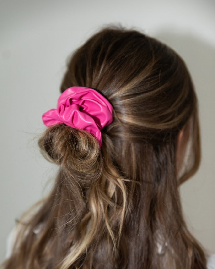 model wearing hot pink pleather scrunchie