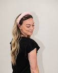model wearing light pink puff spa headband