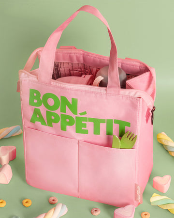 light pink lunch bag with lime green 'bon appetit' across the front