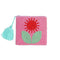 small beaded pink clutch with red and green beaded flower and teal tassel
