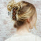 model wearing orange 70's floral vintage lamp inspired hair claw