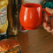 model holding red melamine mug