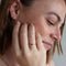 model wearing dainty gold mini heart signet ring
